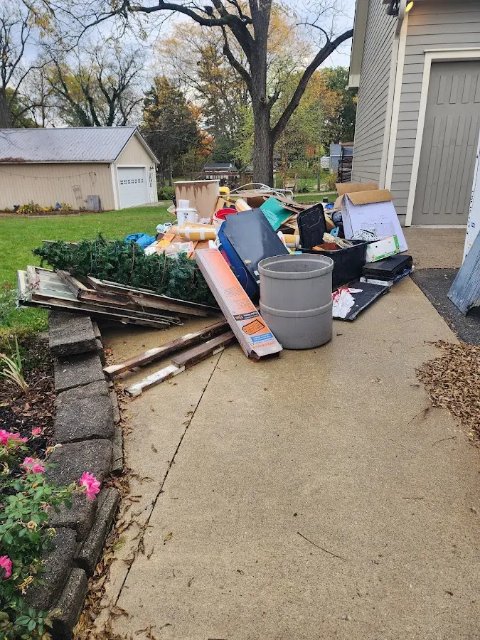 Dumpster being loaded with debris for 12 Yard Dumpster Rental in Onondaga